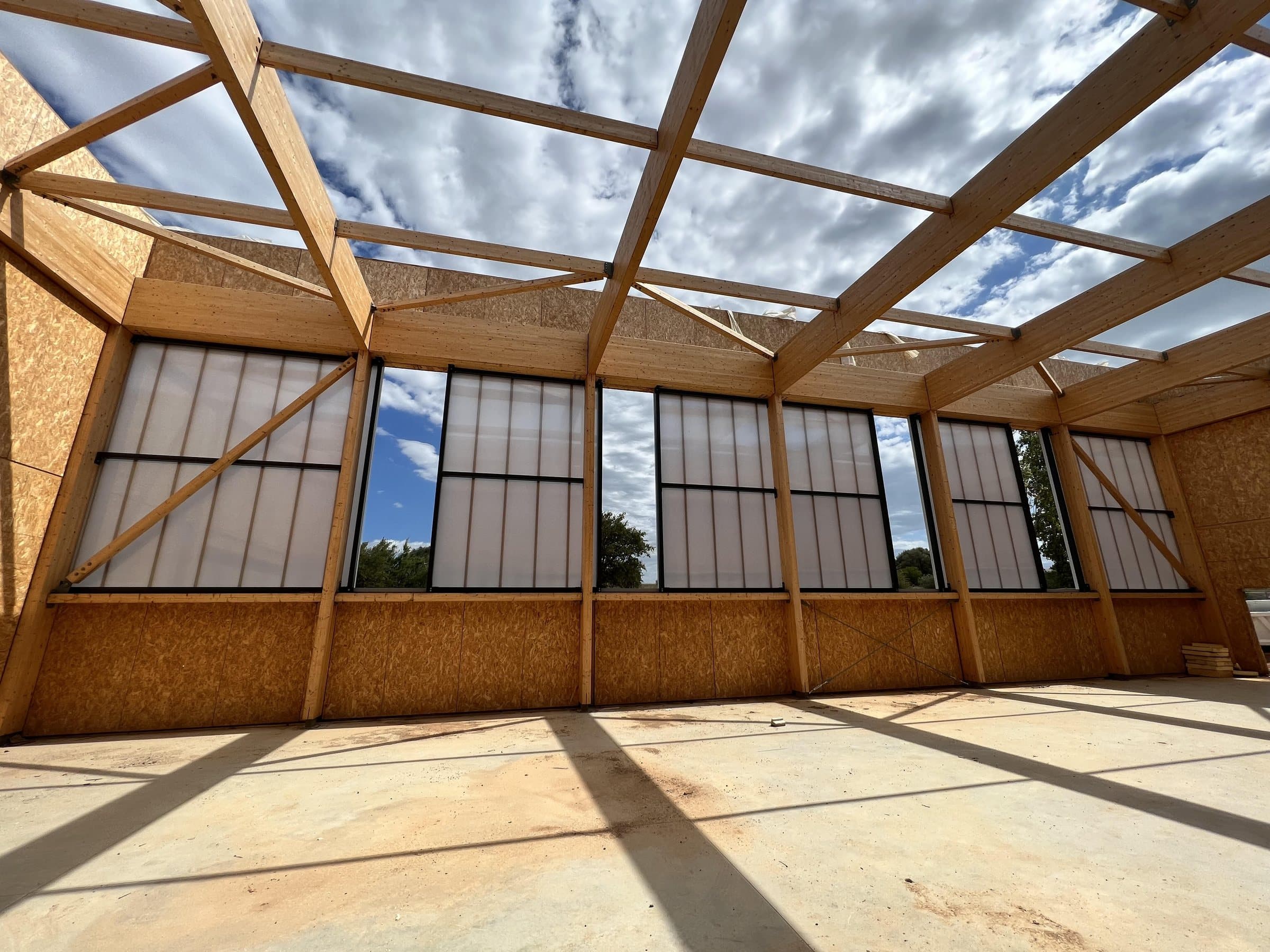 Pórticos de madera contra el cielo, antes de colocar la cubierta